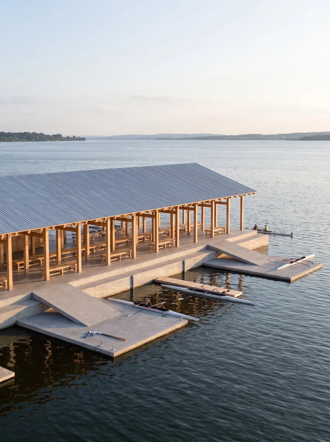 Timber boathouse on the lake in evening light